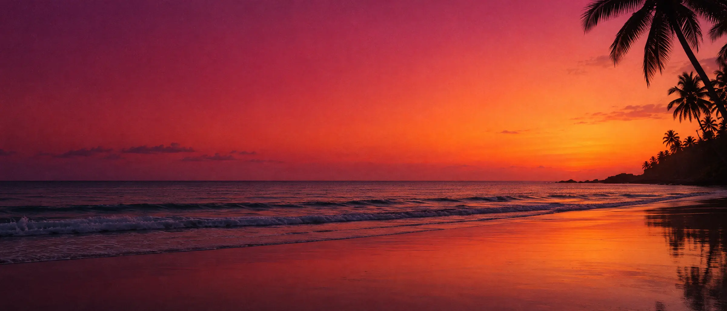 A quiet beach at dusk under a magenta and orange sky